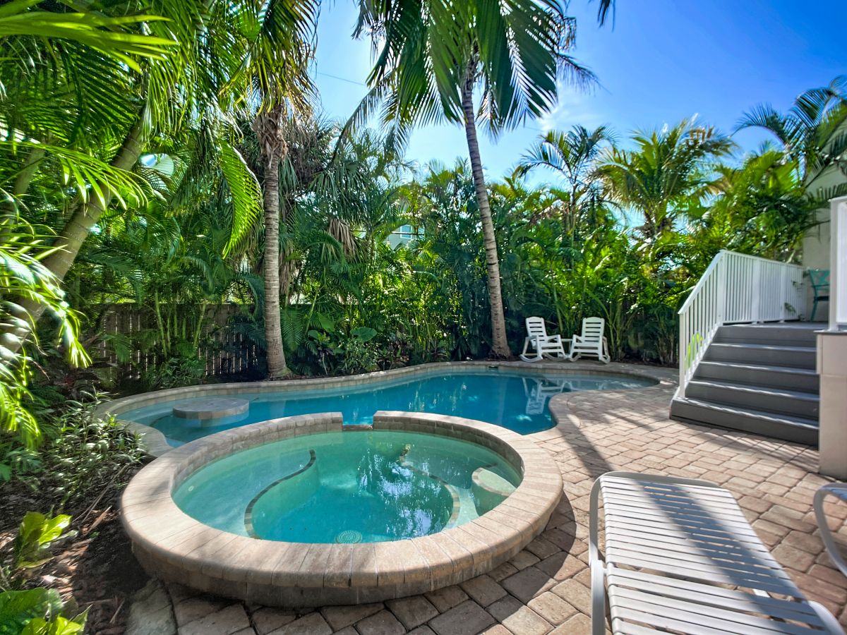 Slip into your private tropical oasis with sparkling pool and spa surrounded by swaying palms and lush greenery