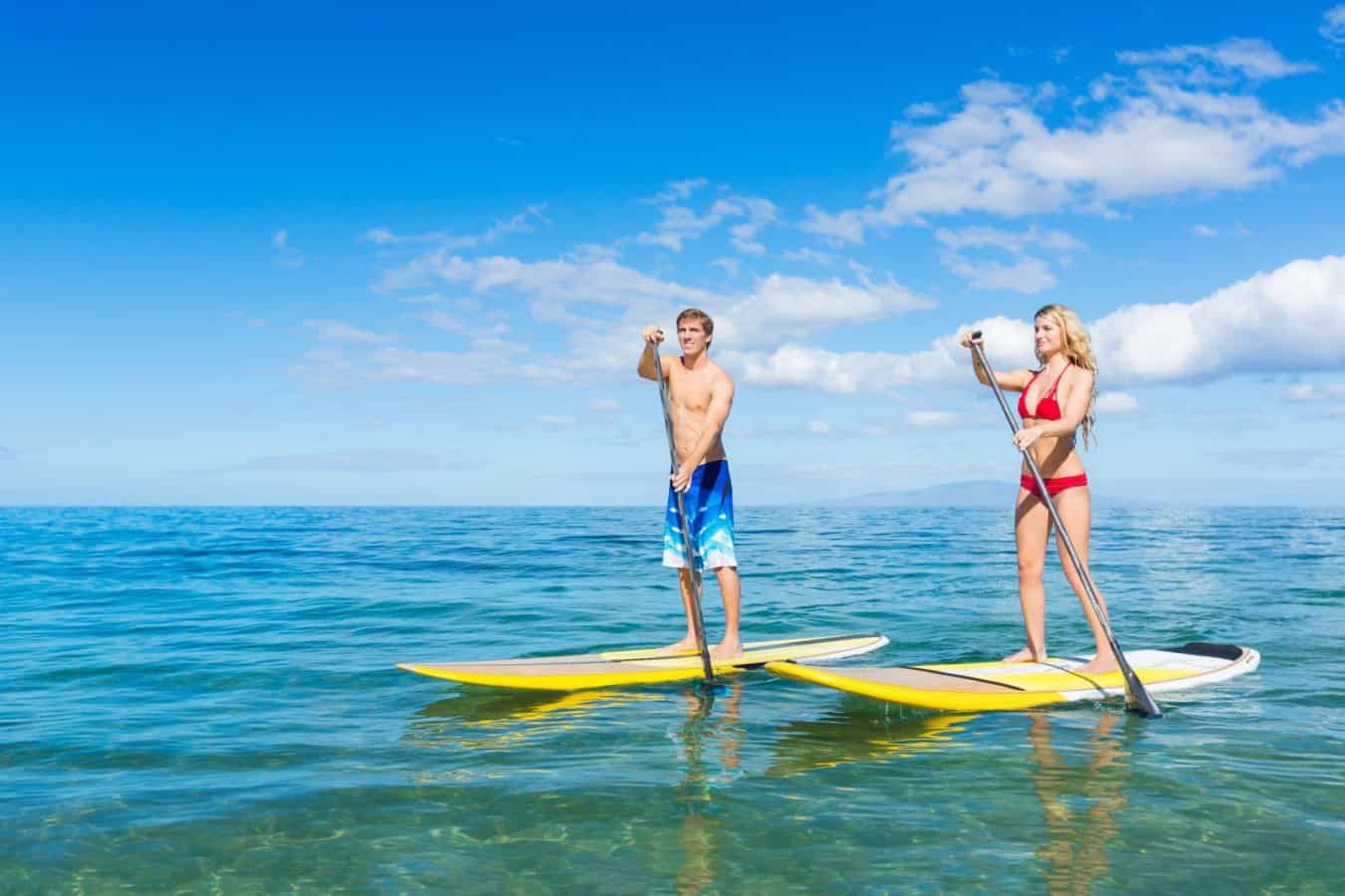 two people paddle boarding in AMI