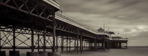 sepia photo of a pier