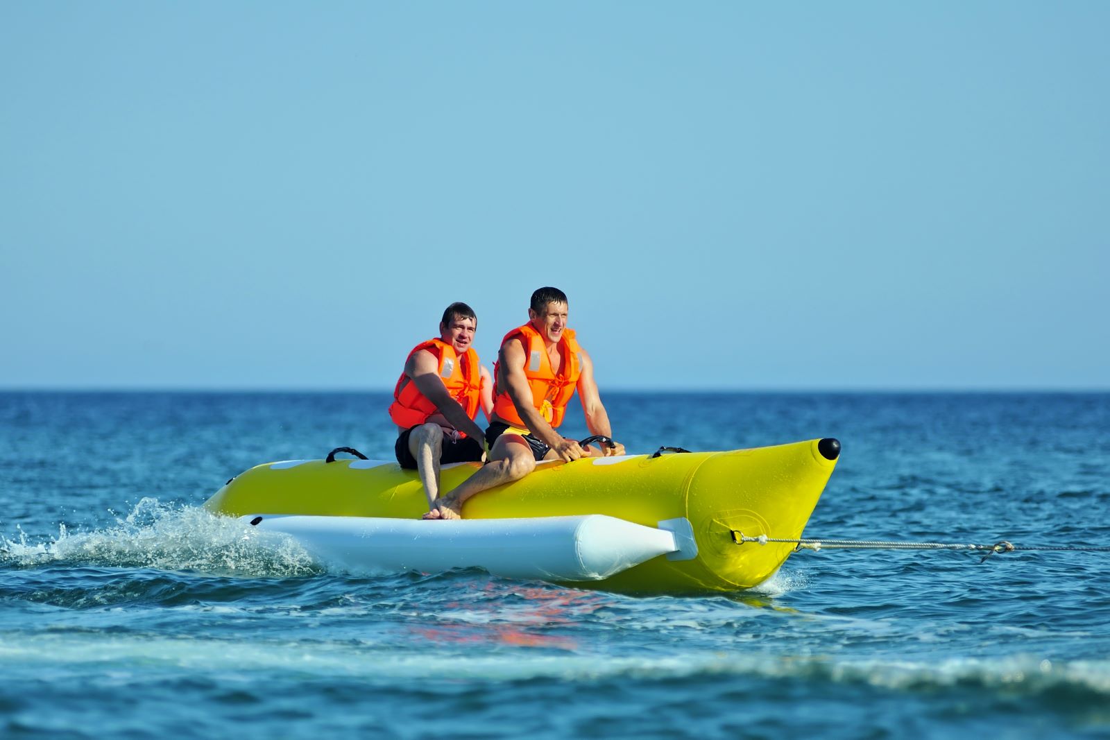 Two boys on the back of a banana boat on Anna Maria Island